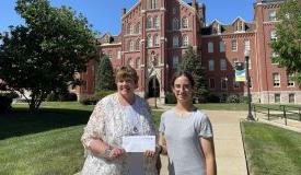 Linda Moore and Hannah Meyer in front of Francis Hall